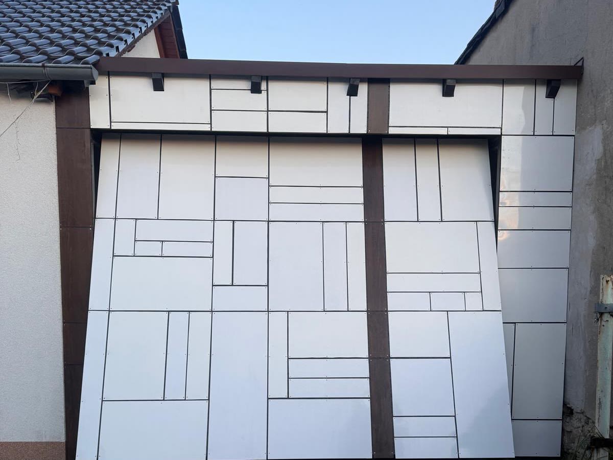 Dasselbe verkleidete Schwingtor beim Öffnen, Platten und braune Leiste schwenken mit